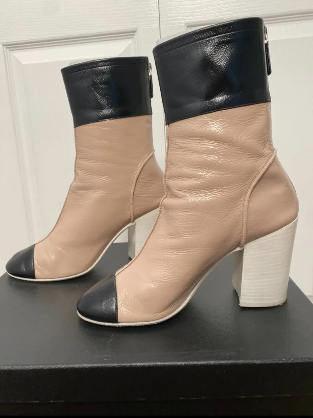 CHANEL Two-Toned Leather Cap-Toe Block Heel Ankle Boots in Beige & Black